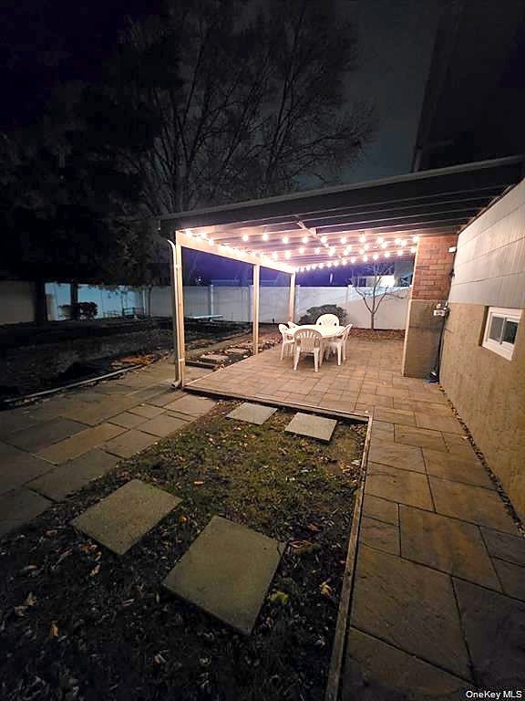 Paver patio and pergola with string lights