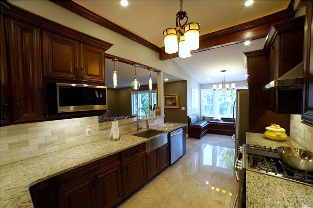 New kitchen — granite, custom cabinetry and stone backsplash