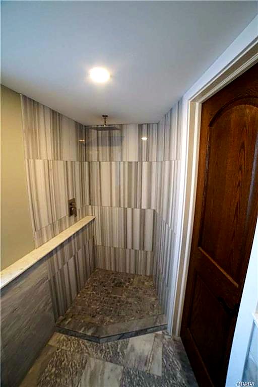 First-floor bathroom in book-matched marble