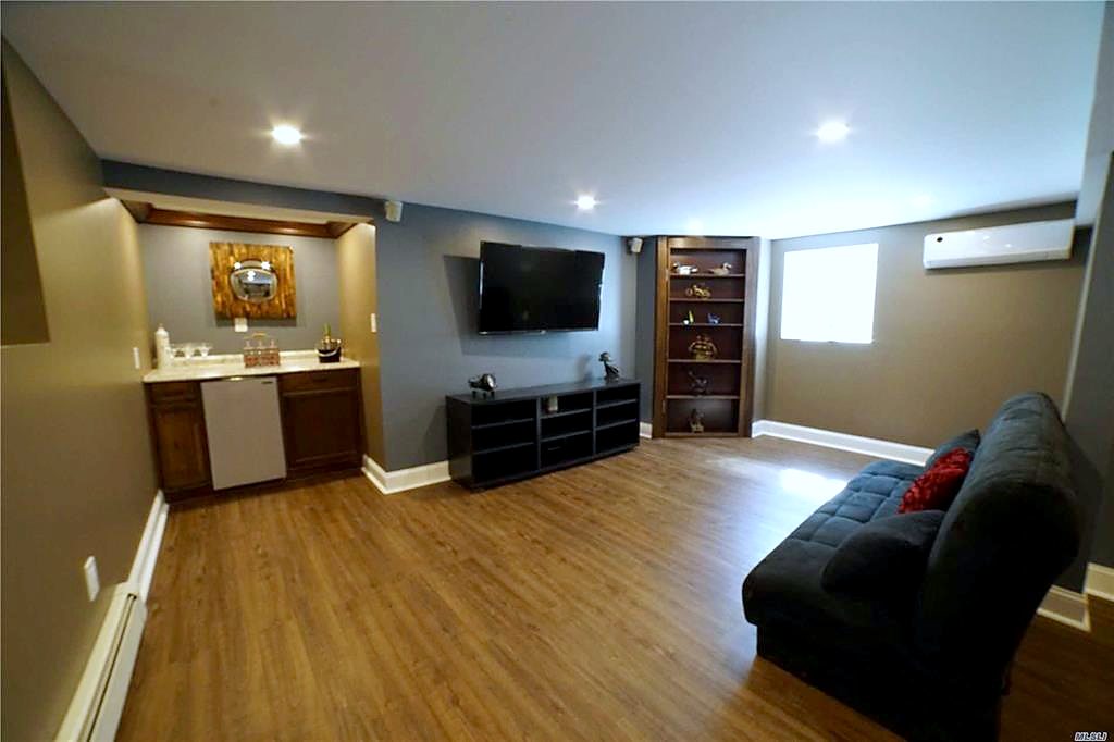 Finished basement with egress window and hidden door