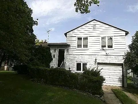 The home as we found it — dated siding and entry
