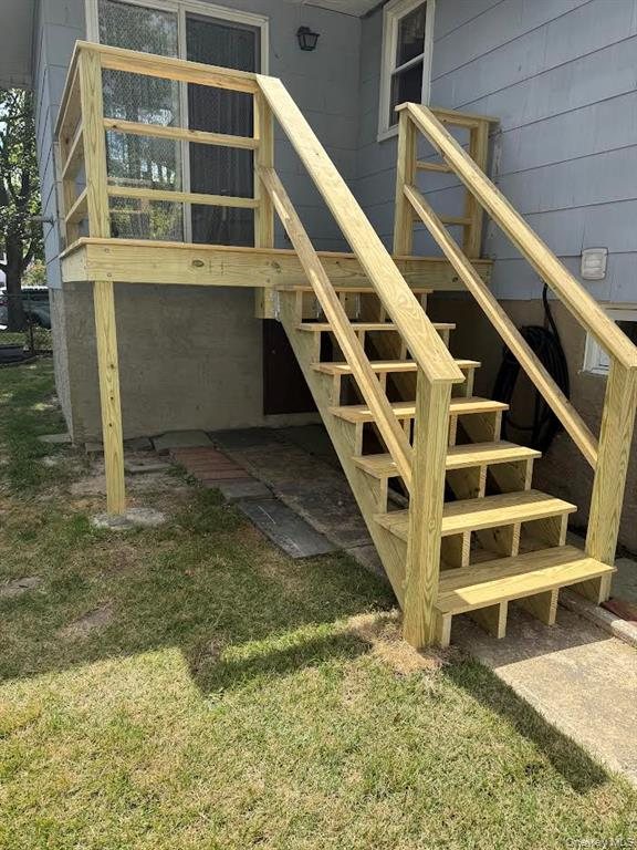 A newly built rear deck and stairs, permitted and legalized before the home was listed